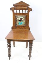 Victorian oak hall chair with Majolica inset tile to back, 90cm high x 44cm wide x 36cm deep