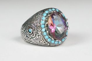 A ladies silver dress ring with large central stone surrounded by turquoise, marked 925 to the inner