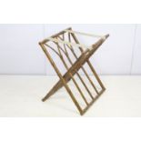 Folding luggage stand, the wooden supports turned to resemble bamboo, with cane work, 57cm high x