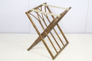 Folding luggage stand, the wooden supports turned to resemble bamboo, with cane work, 57cm high x