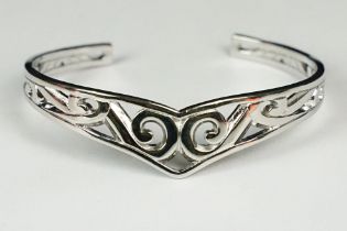 A ladies silver open ended celtic bangle, marked 925 to the verso.