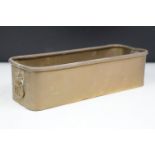 Brass planter of rectangular form with twin lion mask loop handles and rolled upper rim, approx 29cm