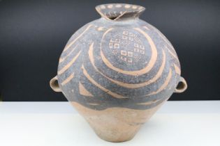 Chinese Neolithic painted terracotta vase having a tapering body with a flared rim and twin ring