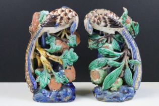 Pair of Chinese antique polychrome pottery spill vases, modelled as birds atop branches with