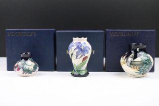 Three Moorcroft vases to include Snowberry, Fly Away Home and New Moon. All in Moorcroft boxes.