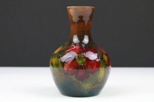 Moorcroft flambe clematis pattern vase having tube lined floral detailing with a waisted neck.