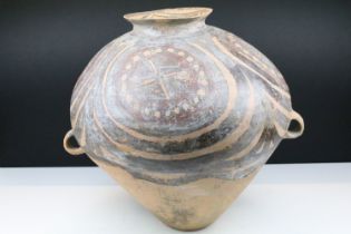 Chinese Neolithic painted terracotta vase having a tapering body with a flared rim and twin ring