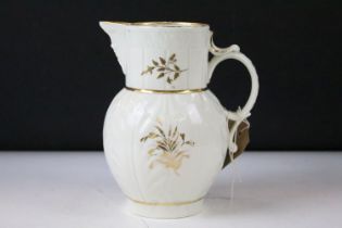 19th Century cabbage leaf jug with mask to spout, gilt florals to sides and initials to front.