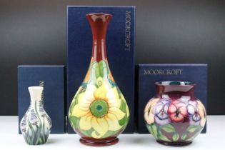 Moorcroft vases to include a Muscari pattern vase, pansy pattern vase and a sunflower pattern vase