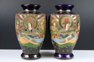 Pair of Japanese vases having gilt and tube lined detailing with deity panels to front and blue