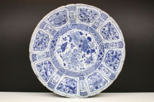 19th Century Chinese blue and white charger plate being hand decorated with chrysanthemum and