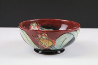 Moorcroft Red Tulip bowl having a tube lined tulip design with red ground raised on a footed base.