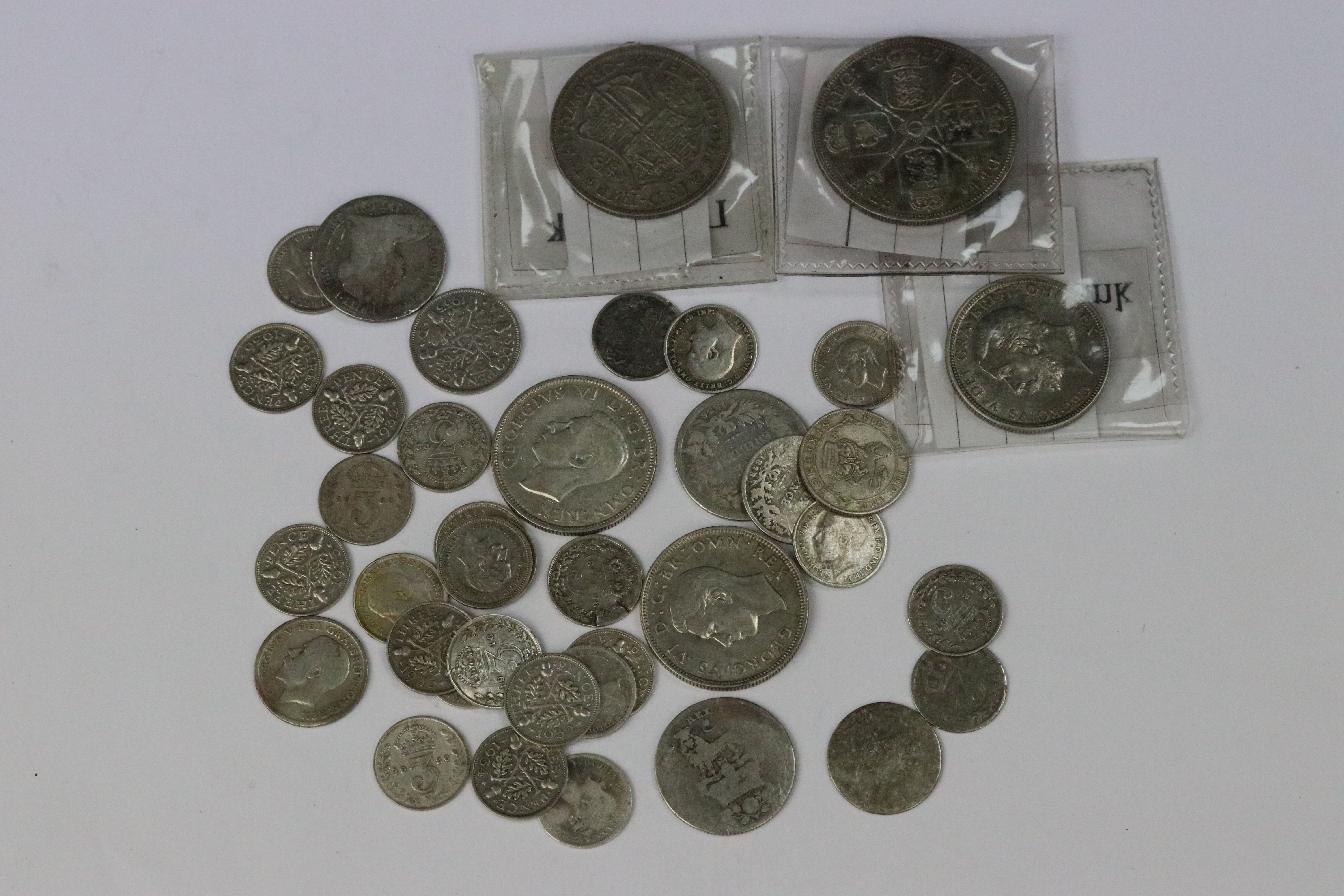 A small collection of British pre decimal silver coins to include double florin, florins, shillings,