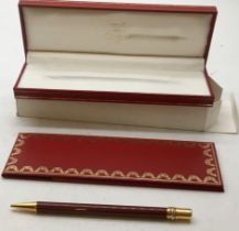 Cartier with original box and documents, packaging and outer packaging a burgundy and gold