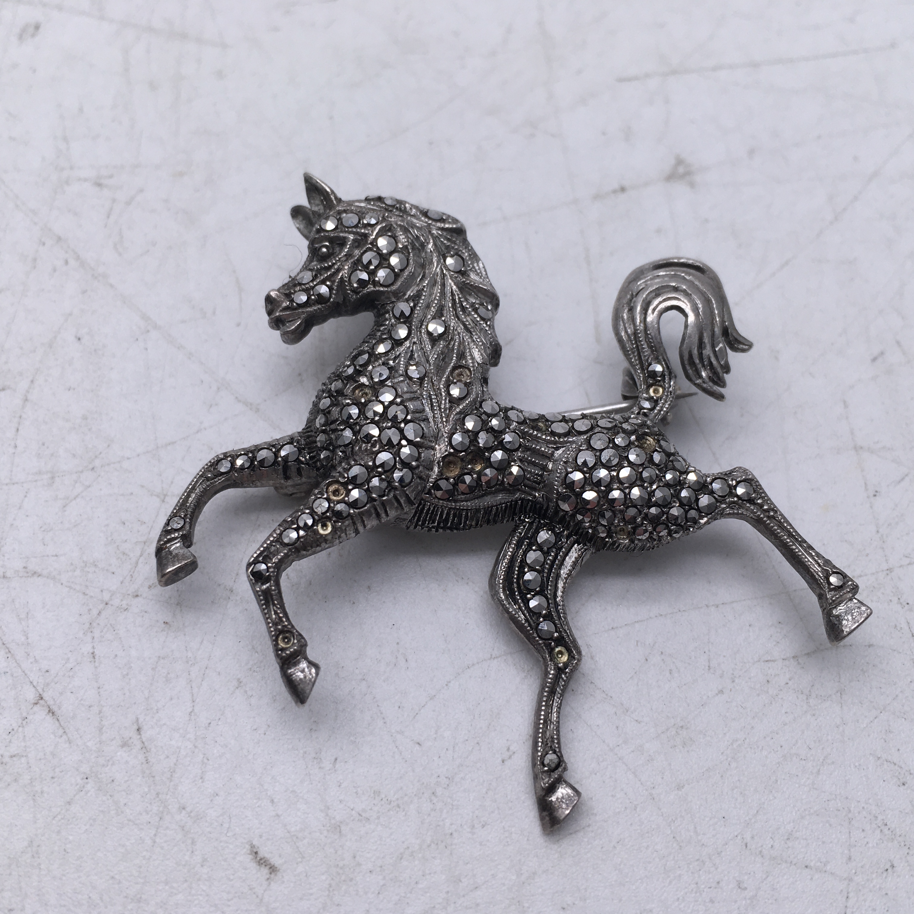 Delicate silver and marcasite brooch modelled as a stylized horse 2inches long - Image 3 of 3