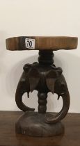 Solid piece of wood carved as a small side table African origin the centre se caration carved as 3