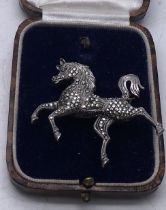 Delicate silver and marcasite brooch modelled as a stylized horse 2inches long