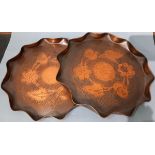 Two Art Nouveau period Cornish art circular copper trays with fruit and flower repoussé design,