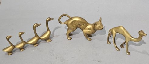 A collection of three brass ornaments featuring a Cat, Ducks and Camel, Various sizes
