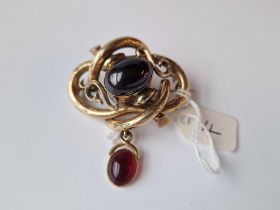 A Victorian Yellow Metal Cabochon Garnet Brooch With Locket Back