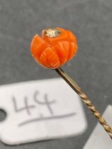 A Coral Topped Stick Pin in the form of a Lotus Flower