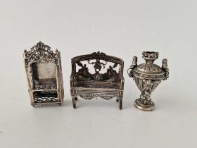 A Miniature Sofa With Pierced Back, A Similar Display Cabinet And A Two Handled Vase, One