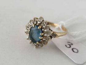 A diamond and blue stone oval cluster ring 9ct size R