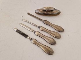 A nail buffer and four implements