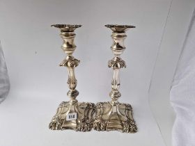 A good large pair of George II style candlesticks with shell decorated bases, baluster shaped