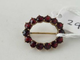 A oval gold mounted garnet brooch