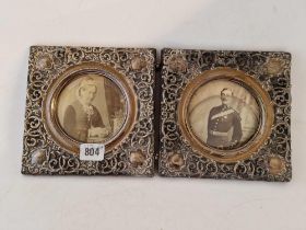 An unusual double folding photo frame with circular apertures within pierced scroll borders, each