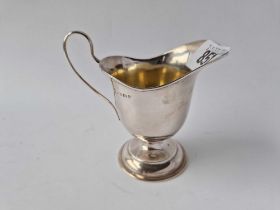 A plain helmet shaped cream jug with loop handle, 3 3/4" high, Birmingham 1923, 54g