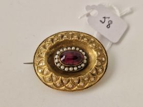 A Victorian cabochon garnet and pearl brooch with locket back, 15ct tested, 9.8 g