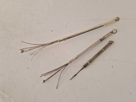 Two swizzle sticks and a tooth pick