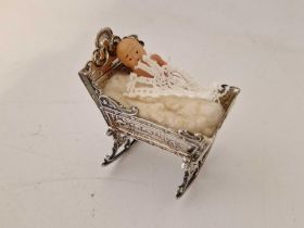 A miniature Cot (Dutch) with chased decoration, 2.5" long