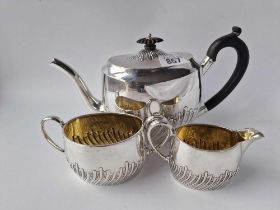 A Victorian three piece tea set with half fluted oval bodies, Sheffield 1886 by HS, 106g