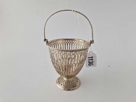 A Georgian style sugar basket with pierced sides, swing handle, 4" high, Birmingham 1935, 96g