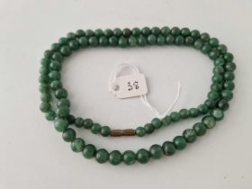 A green hard stone bead necklace 24 inch