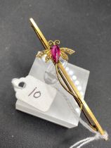 A 9ct bar brooch with red stone and pearl bug with metal pin