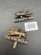 Two cap badges “The Kings Own”