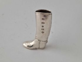 A silver boot match holder with striking part to base, 2.5" high, import mark for Sheffield year