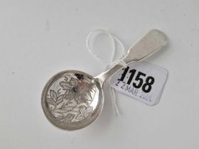 A Victorian fiddle pattern caddy spoon, bowl engraved with flowers, London 1857 by SH DC