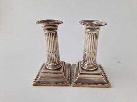 A pair of candlesticks with square beaded edge bases, detachable nozzles, 5" high, Sheffield 1897 by