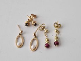 Three pairs of gold earrings sapphire pearl and garnet