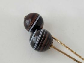 Two Victorian gold and banded agate ball terminal stick pins