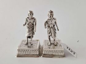 A pair of Eastern figures on square silver bases, 3.5" high, 230g