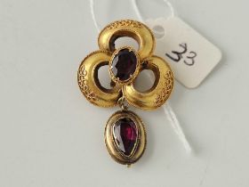 A Victorian gold set garnet drop pendant the drop having a mourning locket