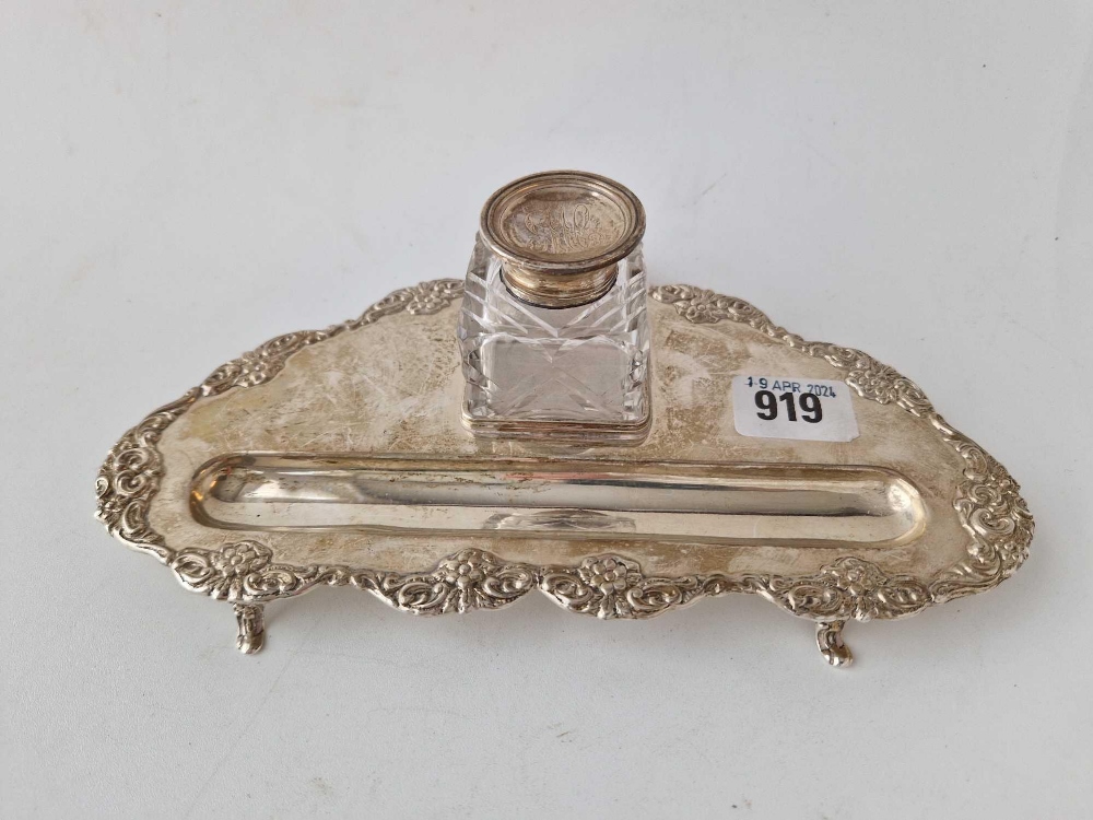A triangular shaped ink stand with applied border and a glass mounted ink pot (damaged), 9" wide,