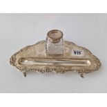 A triangular shaped ink stand with applied border and a glass mounted ink pot (damaged), 9" wide,