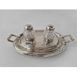 A Victorian oval two bottle ink stand with engraved decoration, mounted ink pots, 11.5 wide,